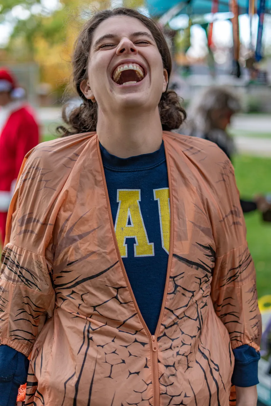 A laughing Rad Rando participant in a brown costume jacket